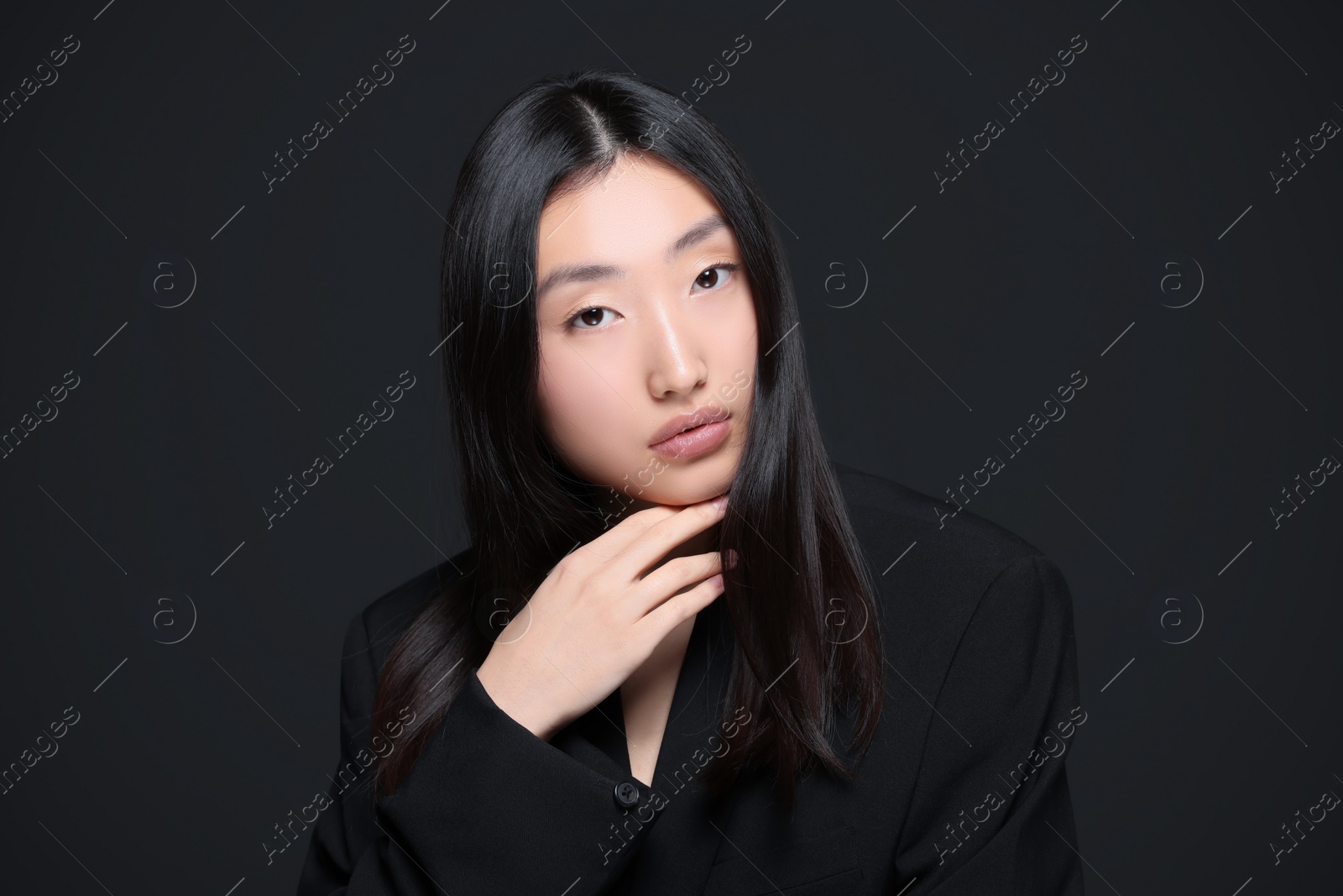 Photo of Portrait of beautiful young Asian woman on black background