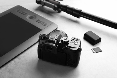 Modern camera on light grey stone table. Video production industry