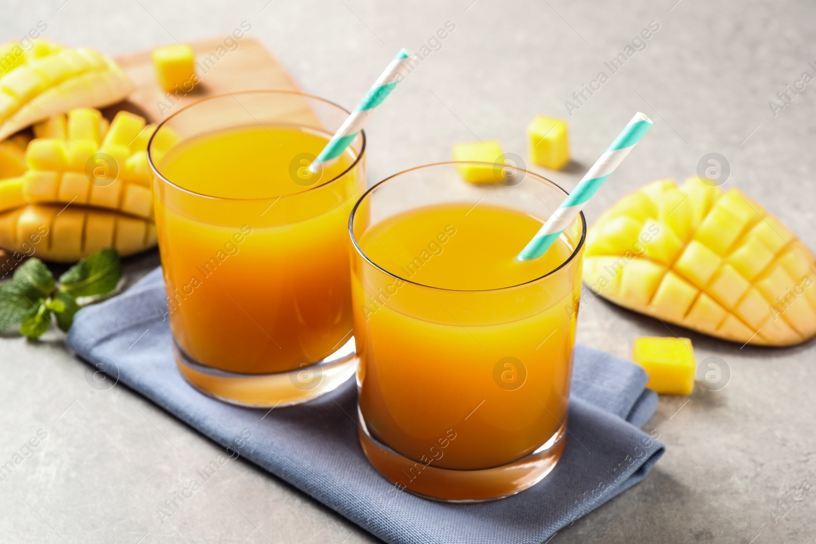 Photo of Fresh delicious mango drink on light table