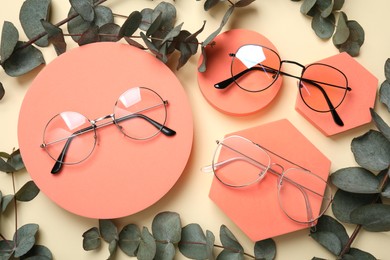 Photo of Flat lay composition with different stylish glasses on beige background