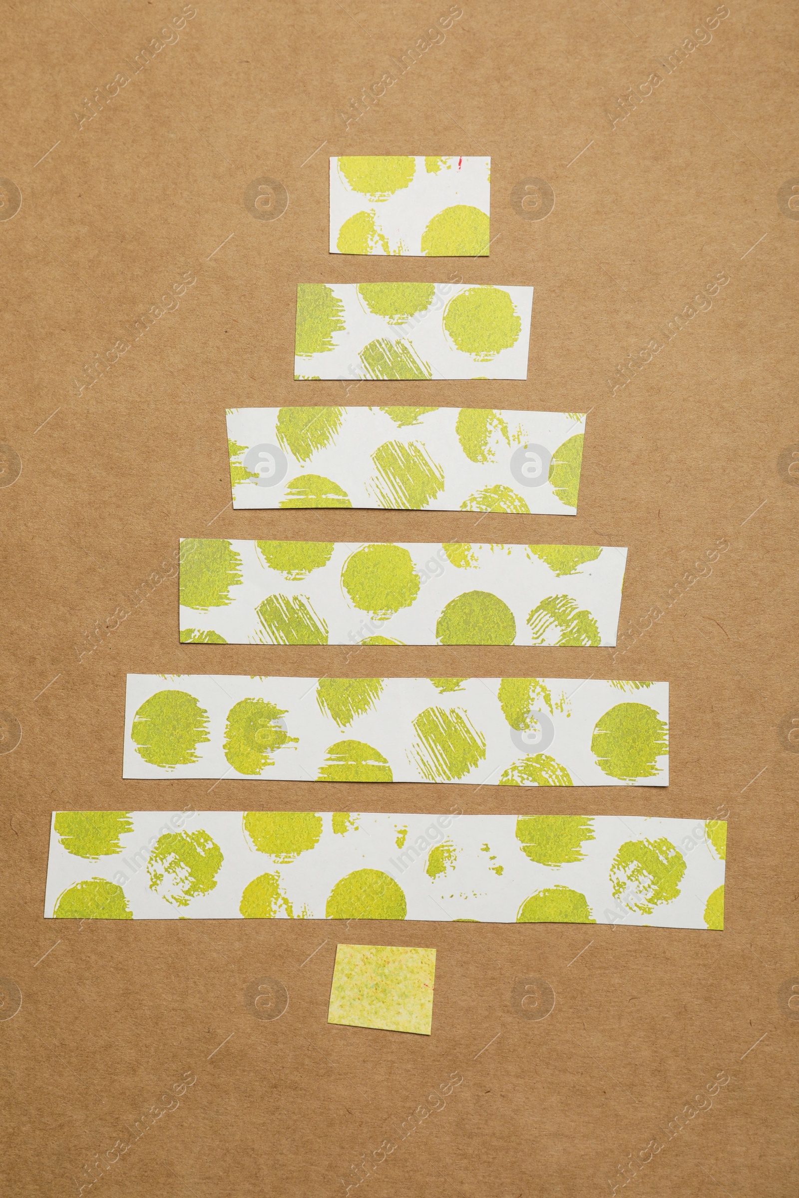 Photo of Christmas tree made of decorative tape on kraft paper, top view