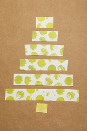 Christmas tree made of decorative tape on kraft paper, top view