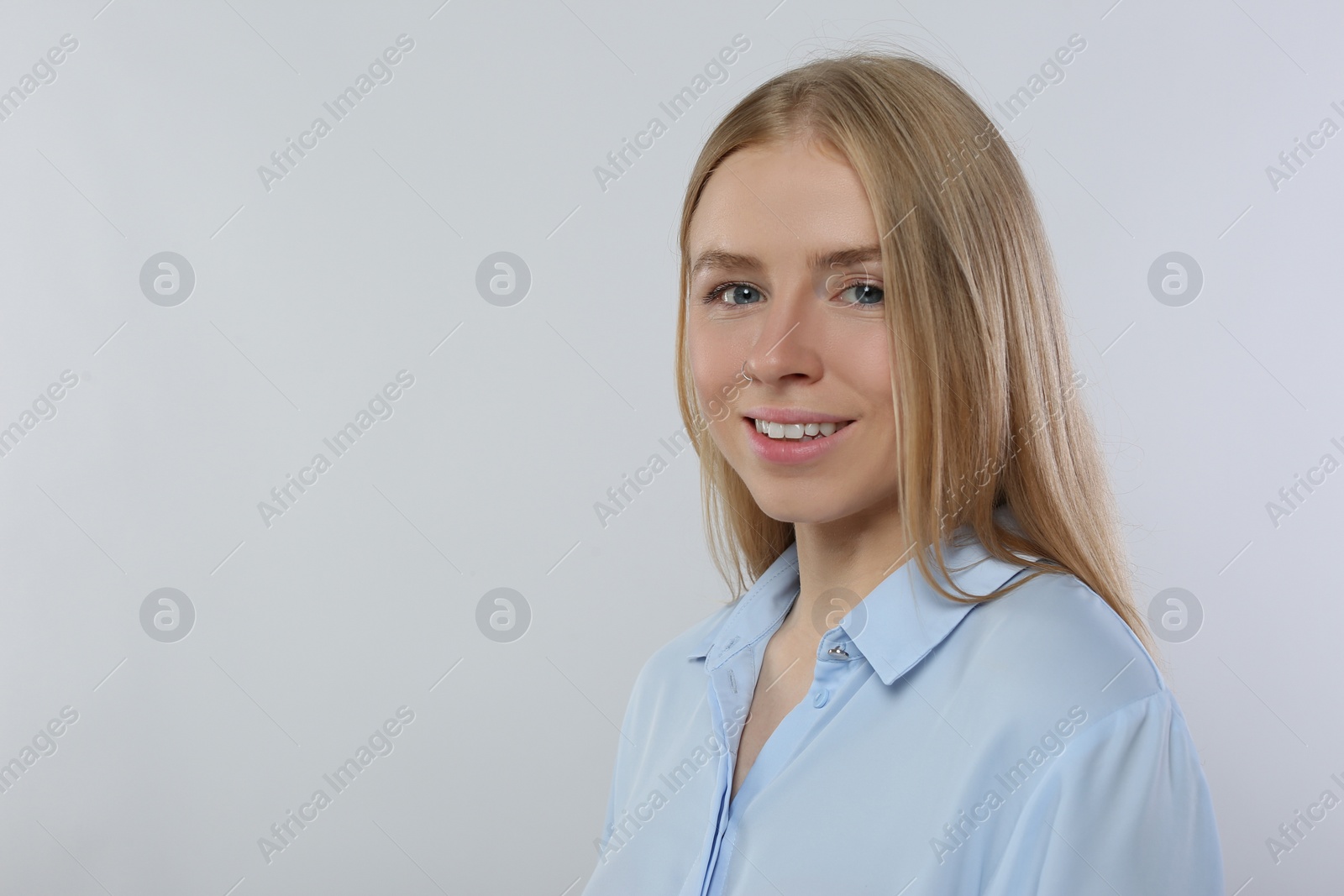Photo of Portrait of beautiful young woman in stylish blouse on white background. Space for text