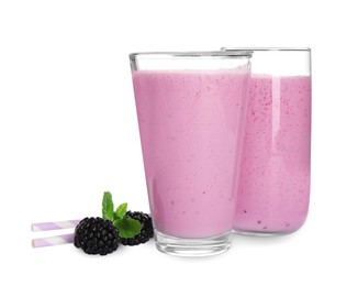 Photo of Freshly made blackberry smoothie in glasses on white background