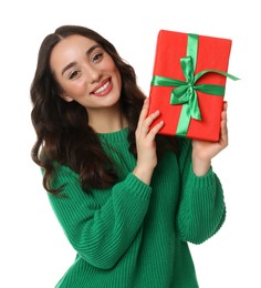 Beautiful young woman with Christmas gift isolated on white
