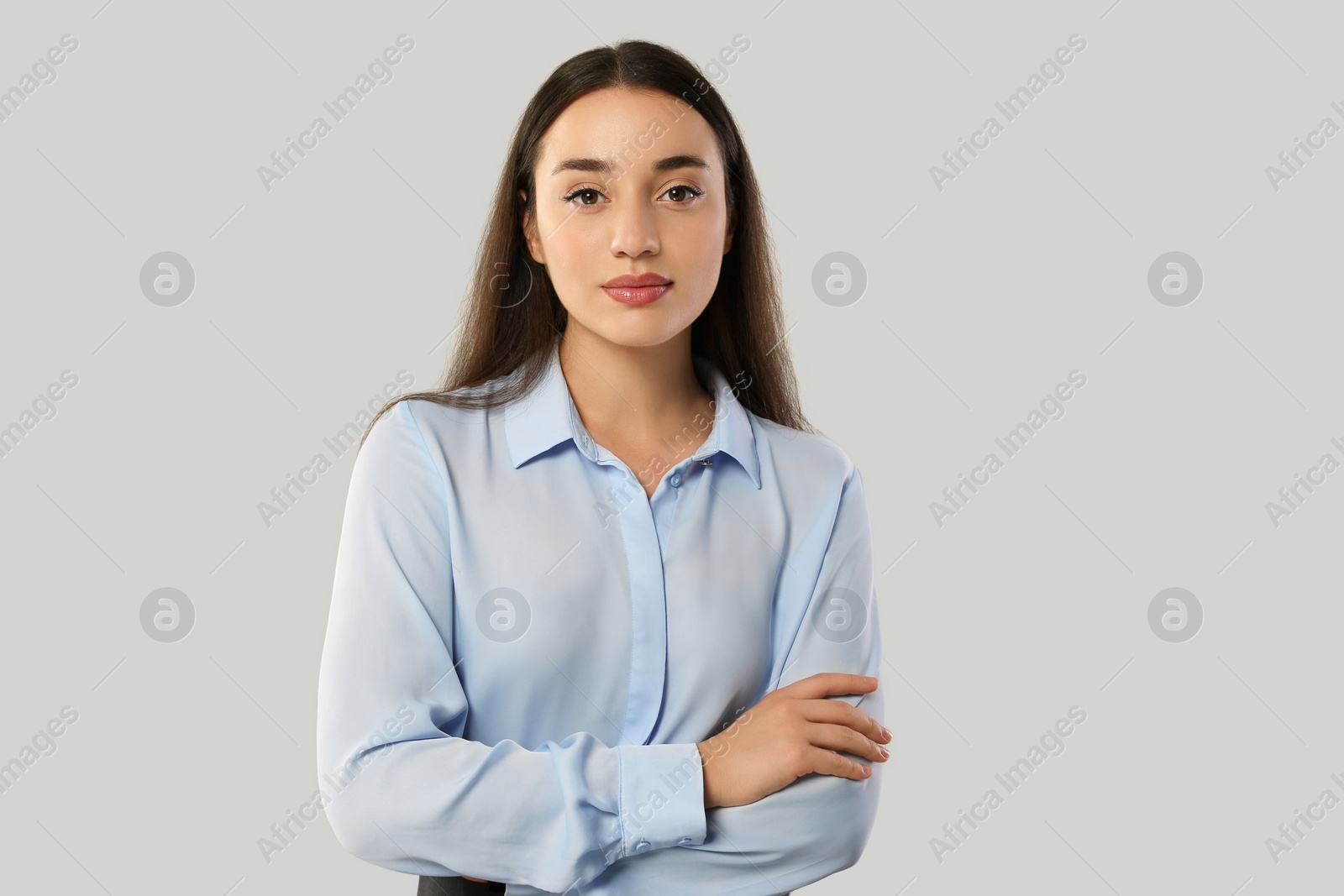 Photo of Portrait of beautiful young woman on light grey background