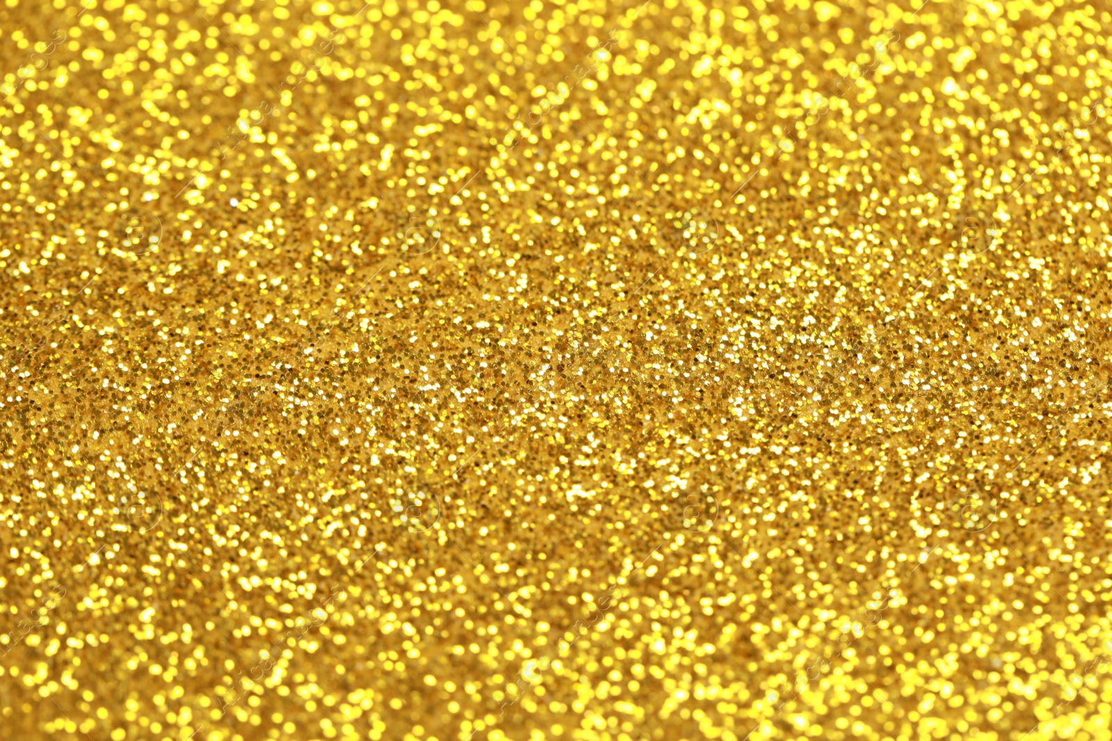 Photo of Beautiful golden shiny glitter as background, closeup