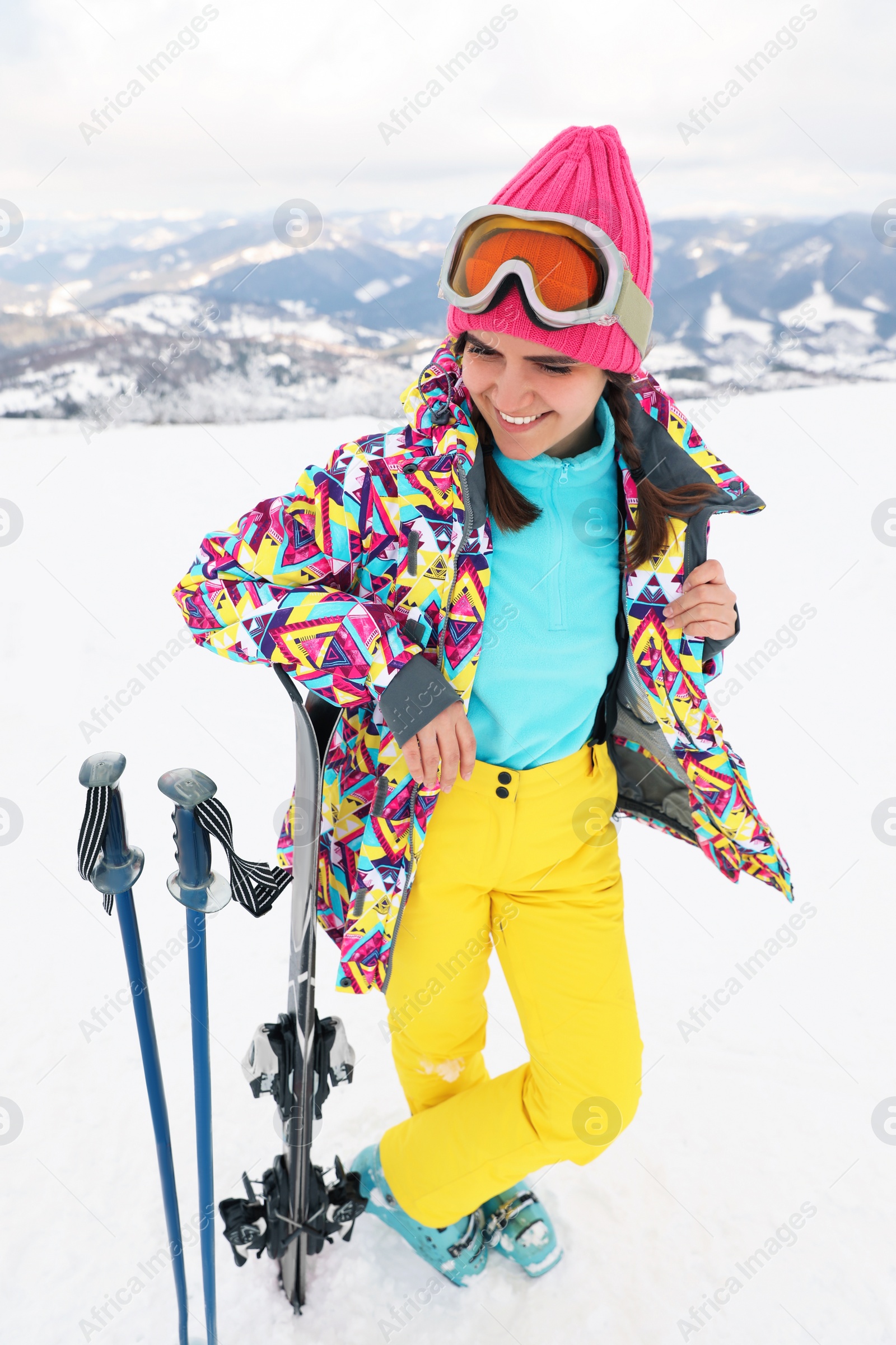 Photo of Young skier wearing winter sport clothes outdoors