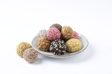 Different delicious vegan candy balls on white background