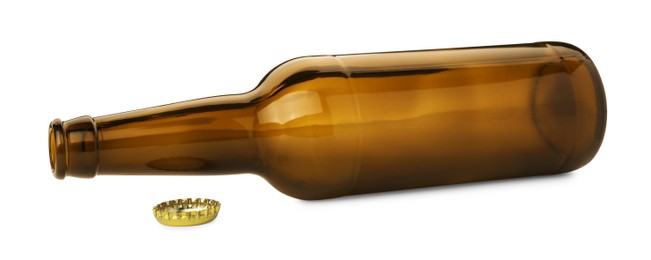 One empty brown beer bottle and cap isolated on white