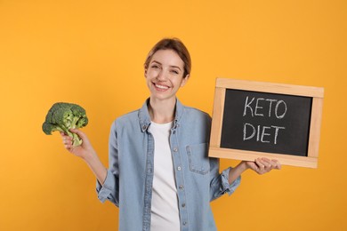 Woman holding blackboard with phrase Keto Diet and broccoli on yellow background