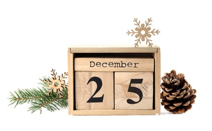 Photo of Wooden block calendar and festive decor on white background