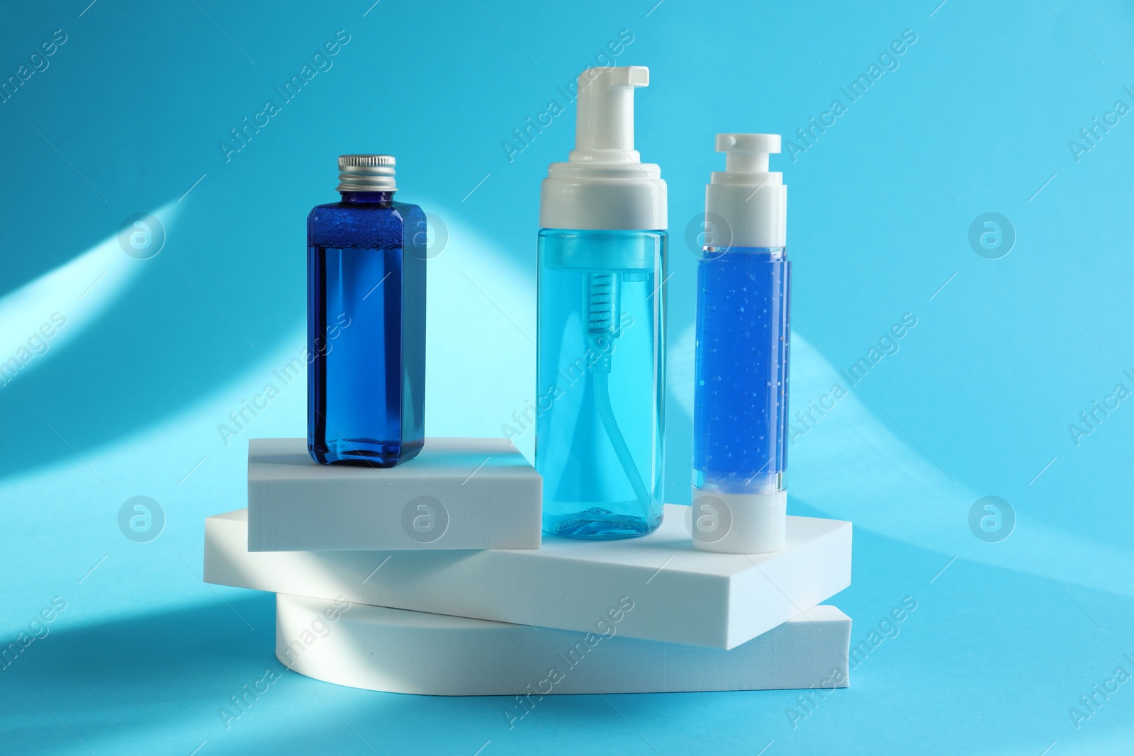 Photo of Set of luxury cosmetic products on light blue background