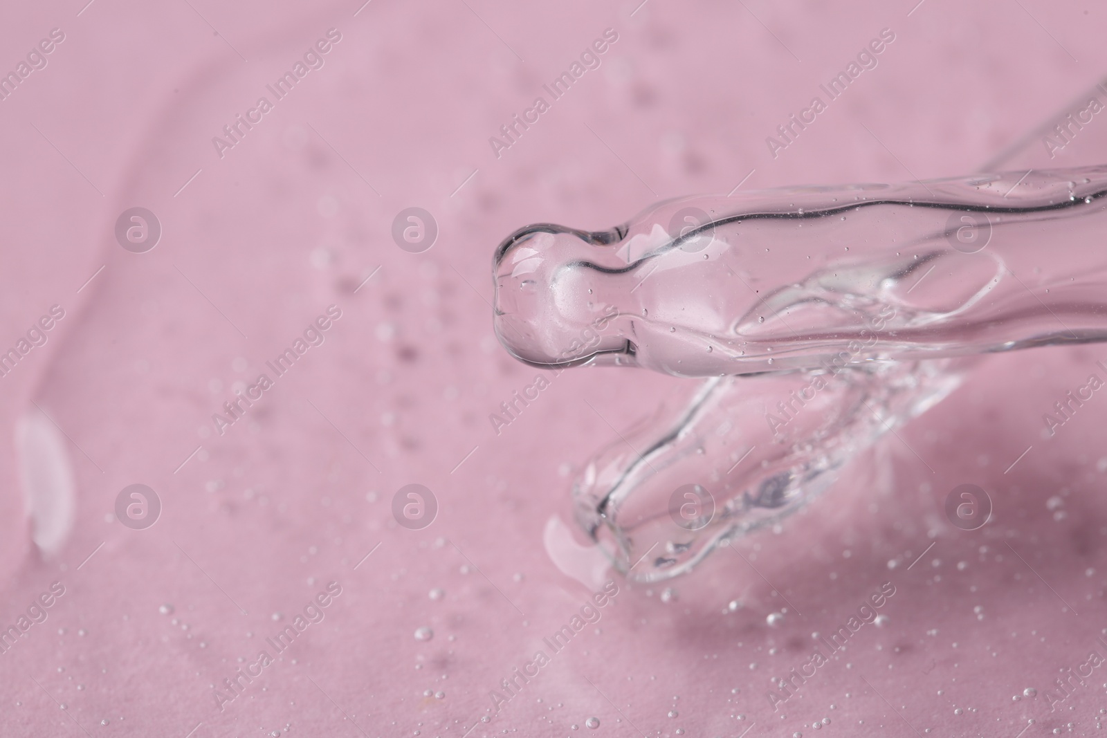 Photo of Pipettes with cosmetic serum on pink background, closeup. Space for text
