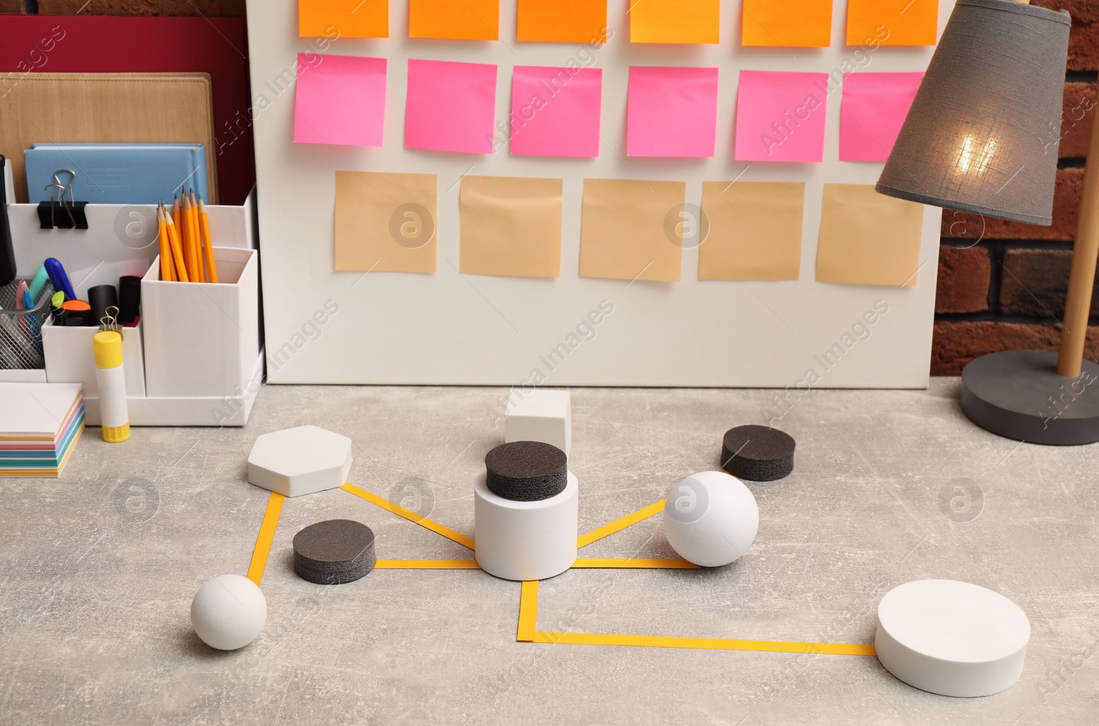 Photo of Business process scheme with geometric figures and stationery on light grey table