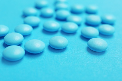 Photo of Blue pills on color background