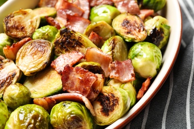 Delicious Brussels sprouts with bacon in baking pan, closeup