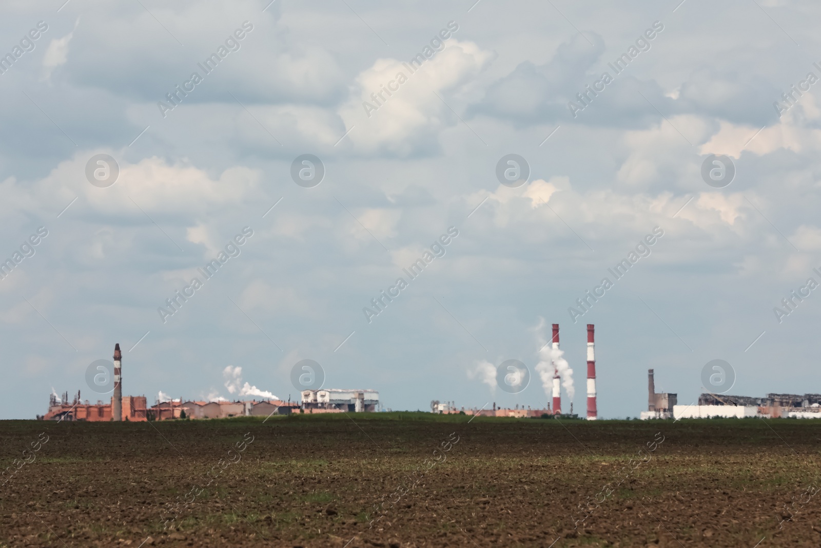 Photo of Industrial factory near field on cloudy day