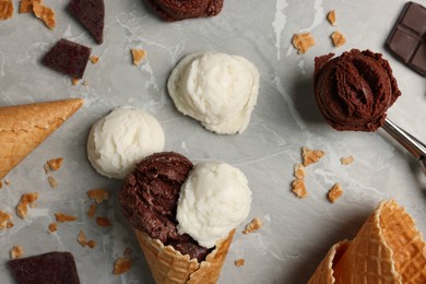 Photo of Flat lay composition with tasty ice cream scoops, pieces of chocolate and waffle cones on light marble table