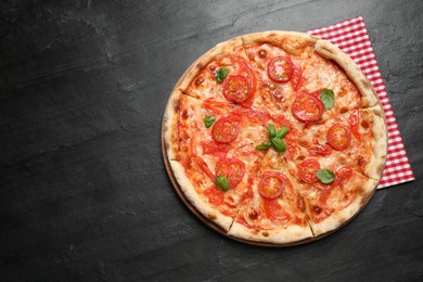 Photo of Delicious pizza Margherita on dark grey table, top view. Space for text