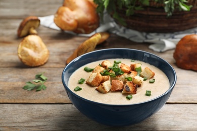 Bowl of fresh homemade mushroom soup on wooden table