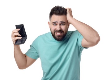 Confused man showing empty wallet on white background