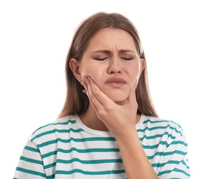 Young woman suffering from toothache on white background