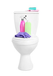 Toilet bowl and cleaning supplies on white background