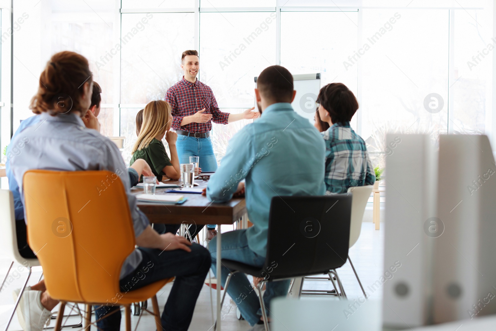 Photo of Male business trainer giving lecture in office