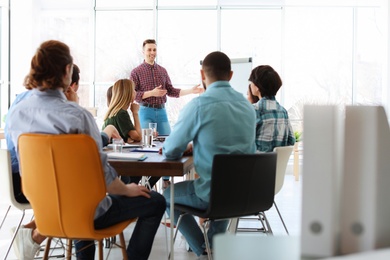 Photo of Male business trainer giving lecture in office