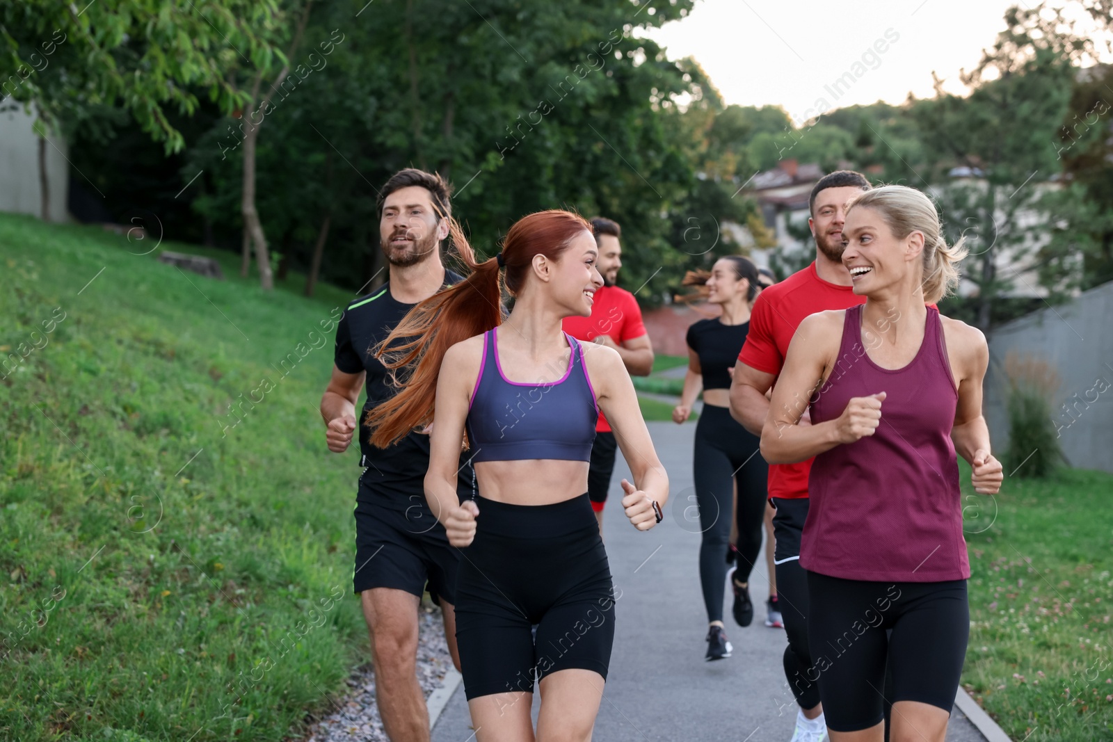 Photo of Group of people running outdoors. Active lifestyle