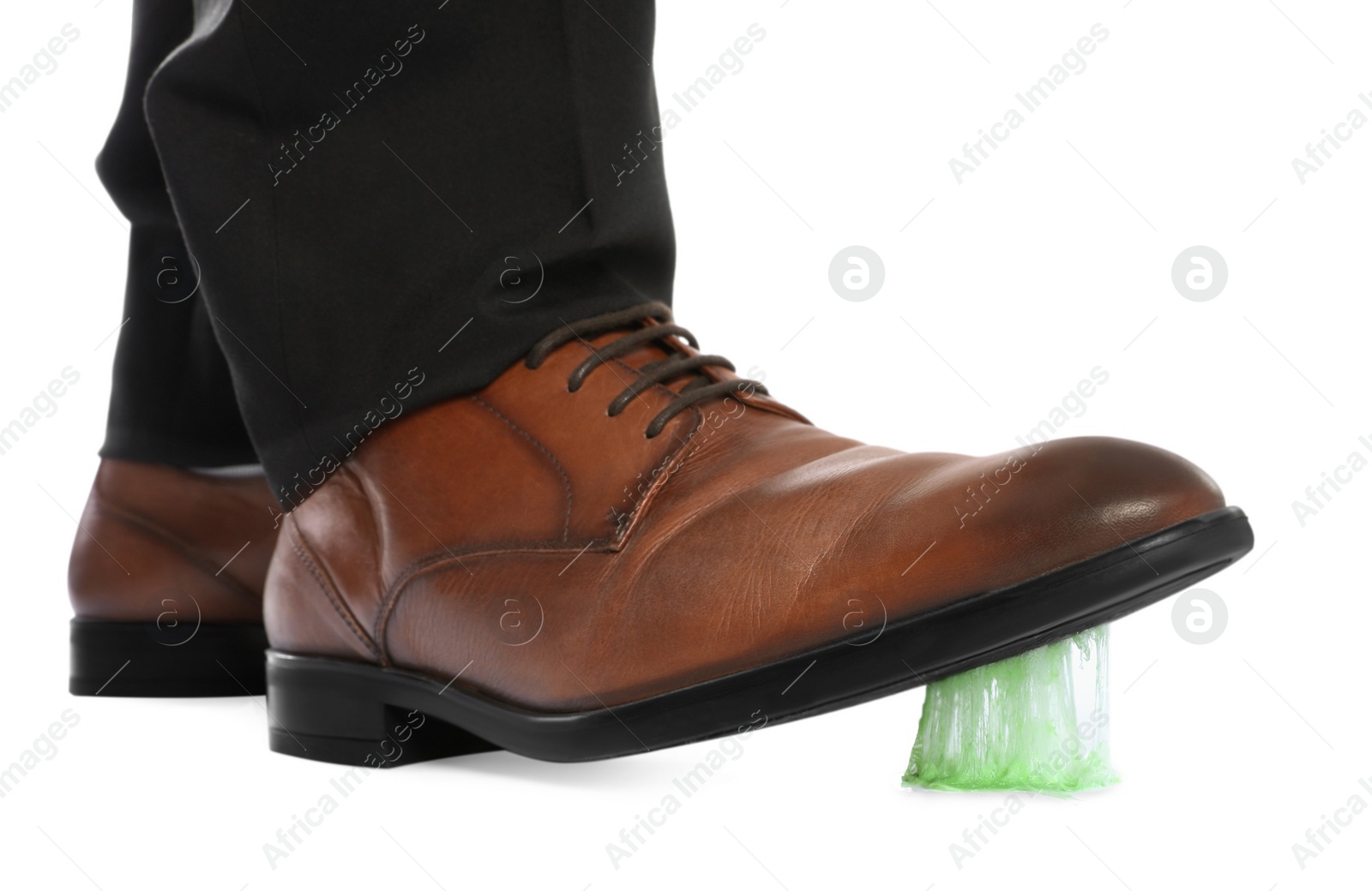 Photo of Man stepping into chewing gum on white background, closeup