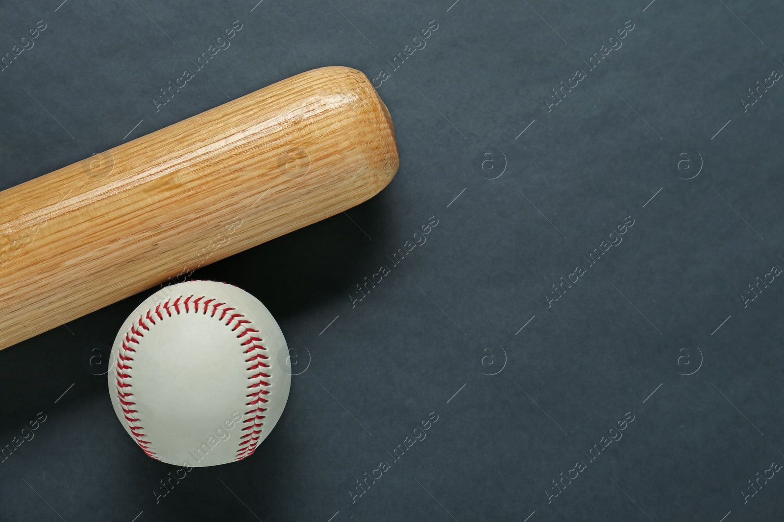 Photo of Wooden baseball bat and ball on black background, flat lay. Space for text