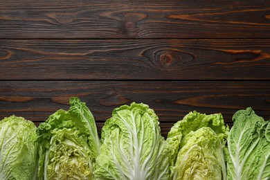 Fresh ripe Chinese cabbages on wooden table, flat lay. Space for text