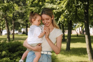 Photo of Happy mother with her daughter walking in park