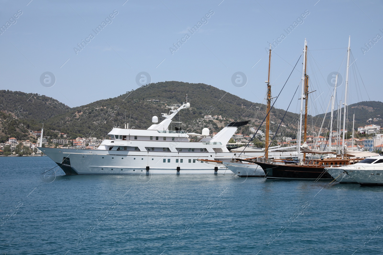 Photo of Beautiful view of different boats in sea near shore on sunny day