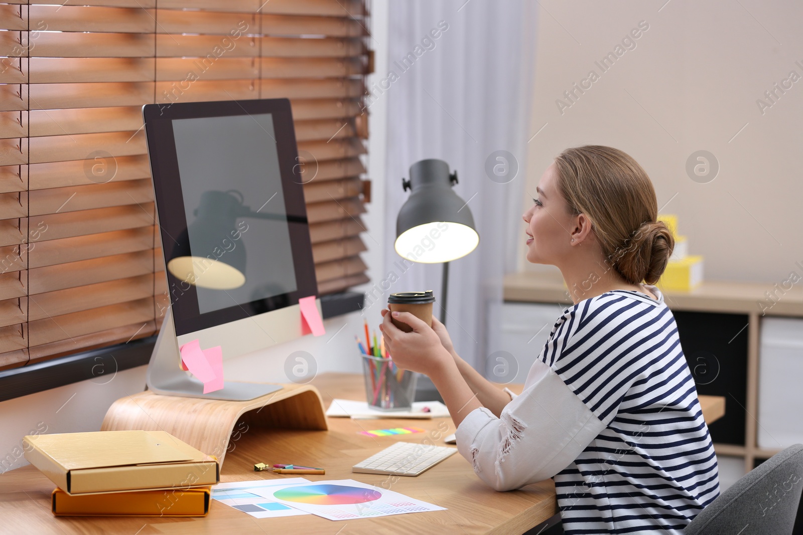 Photo of Female designer working at desk in office