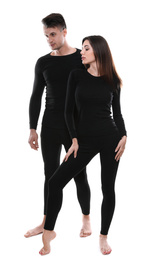 Couple wearing thermal underwear isolated on white