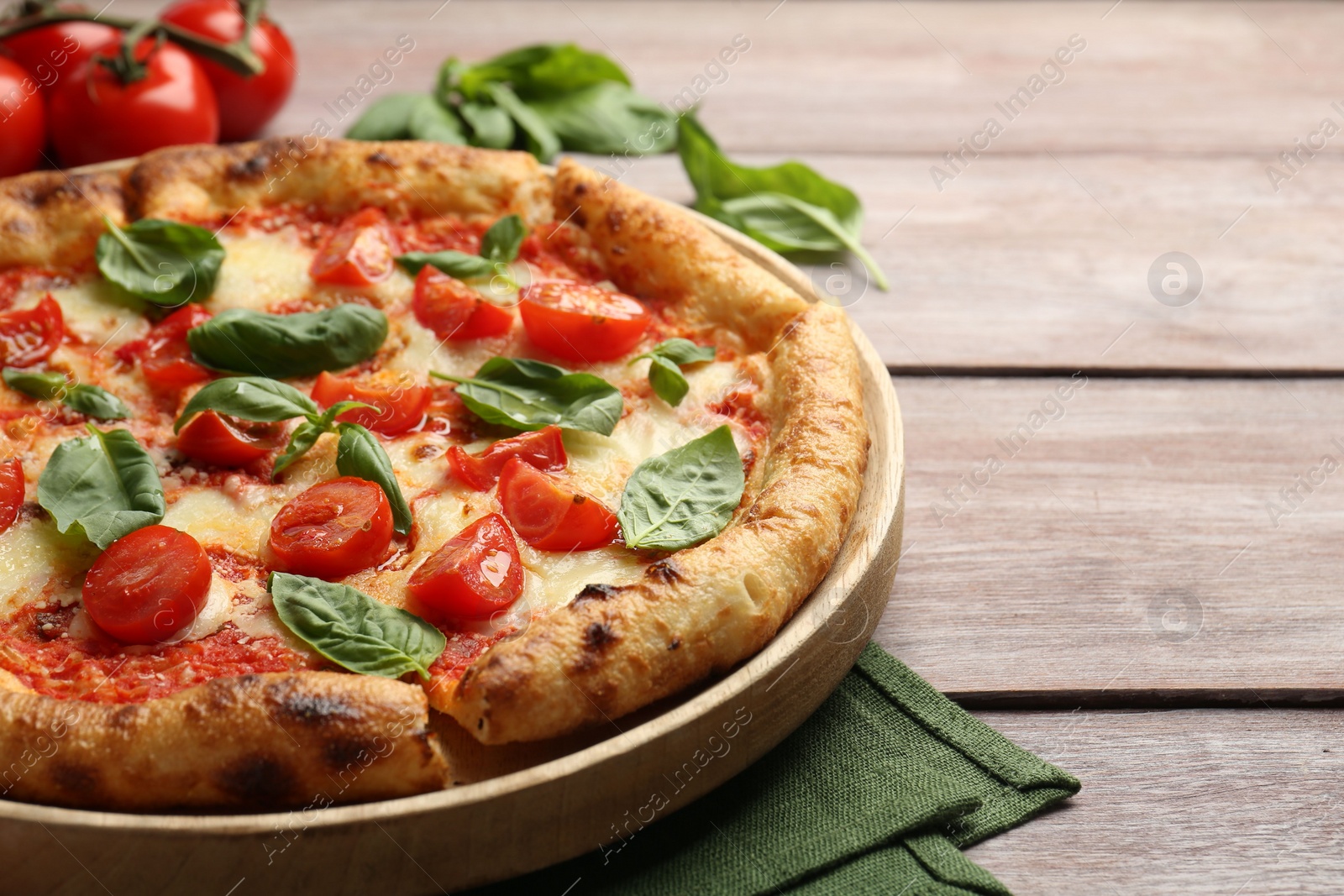 Photo of Delicious Margherita pizza on wooden table, closeup