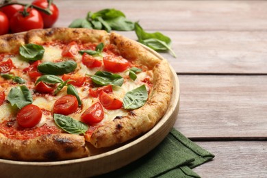 Photo of Delicious Margherita pizza on wooden table, closeup