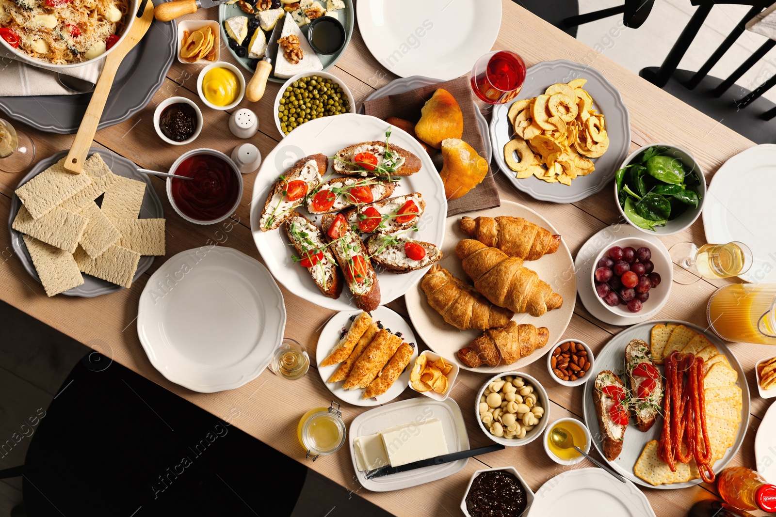 Photo of Brunch table setting with different delicious food indoors, top view