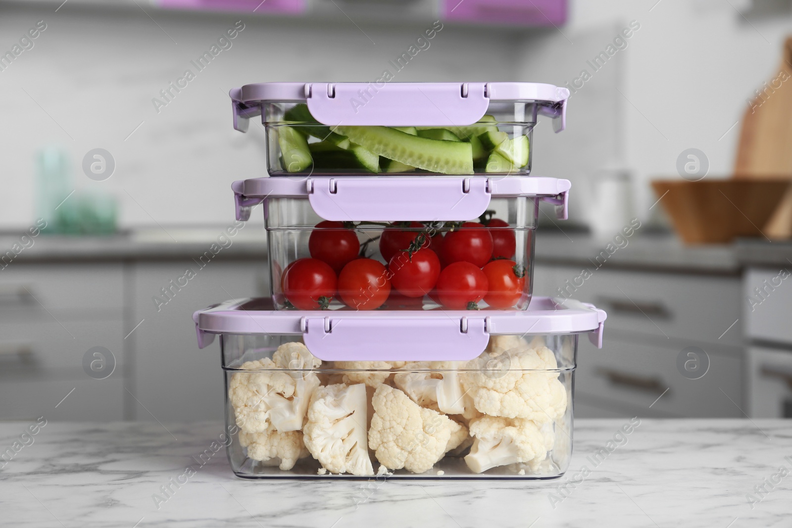 Photo of Boxes with fresh raw vegetables on table in kitchen