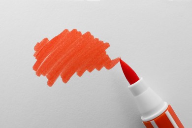 Stroke drawn with orange marker and highlighter isolated on white, top view