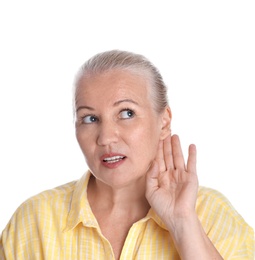 Mature woman with hearing problem on white background