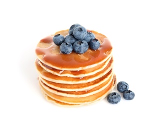 Stack of delicious pancakes with fresh blueberries and syrup on white background