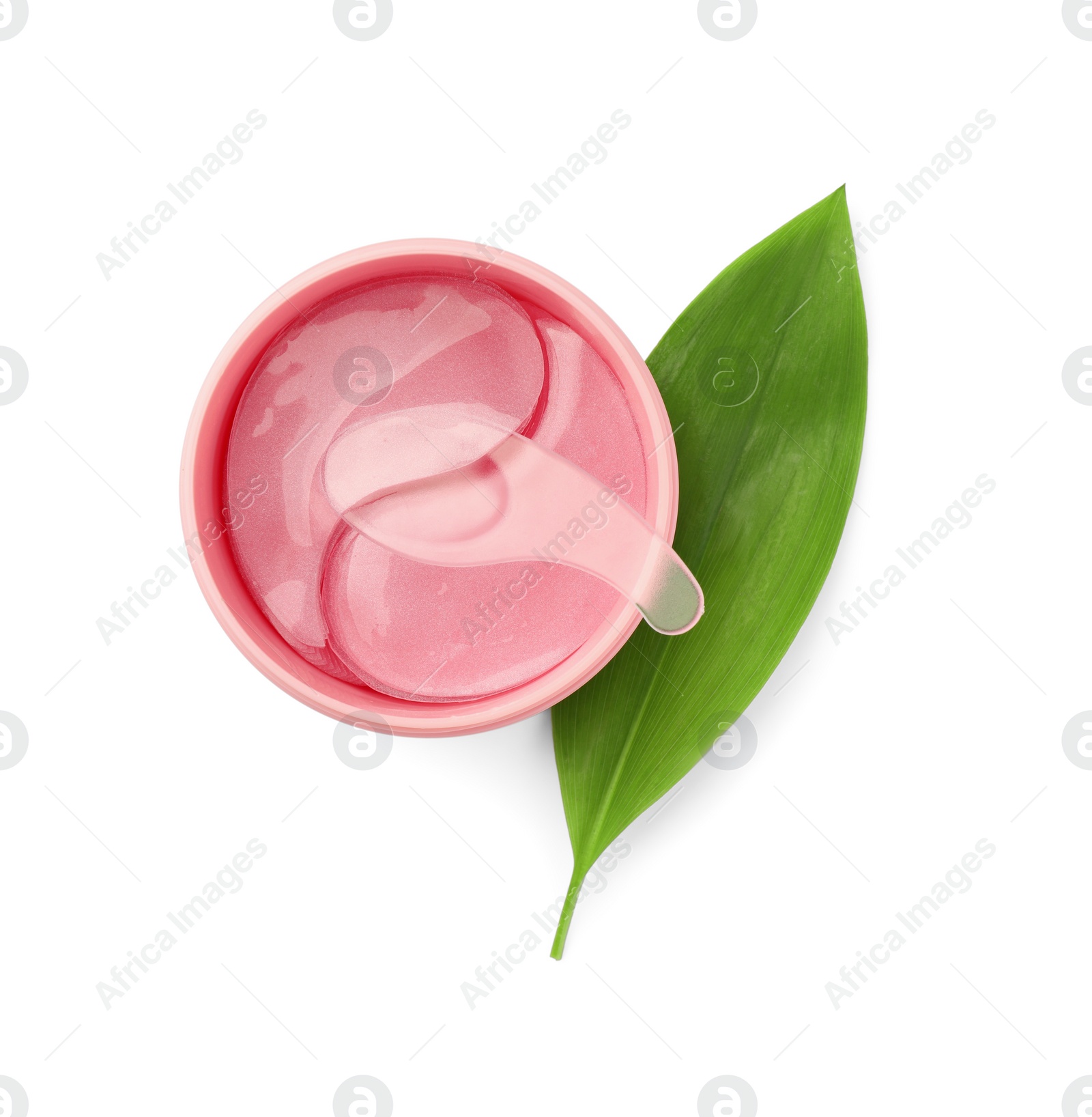 Photo of jar of under eye patches with spoon and green leaf isolated on white, top view. Cosmetic product