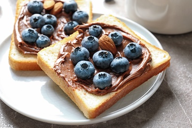 Photo of Toast bread with blueberries and chocolate paste on plate