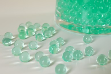 Photo of Mint vase filler on white table, closeup. Water beads