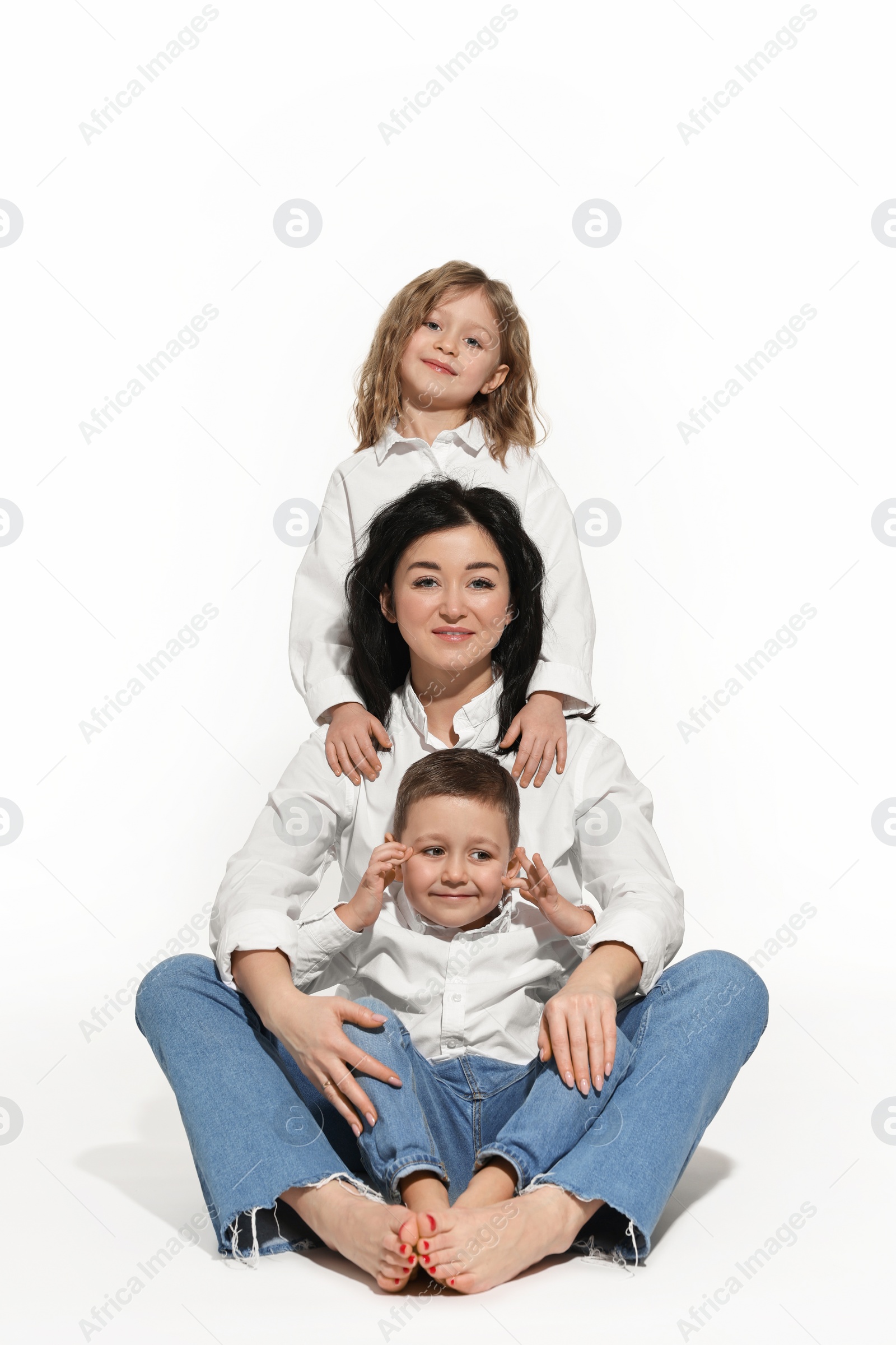 Photo of Little children with their mother on white background