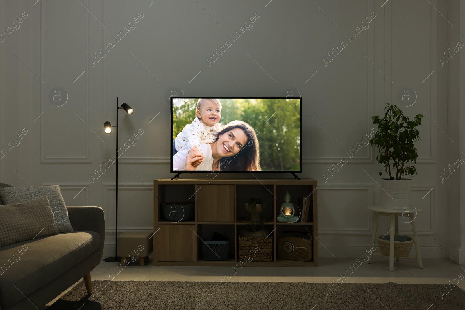 Image of Modern TV set on wooden stand in room